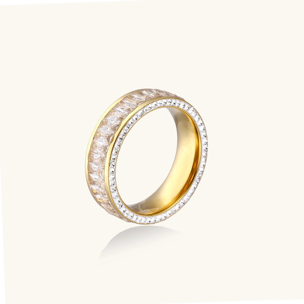 Gold ring with diamond accents on a white background