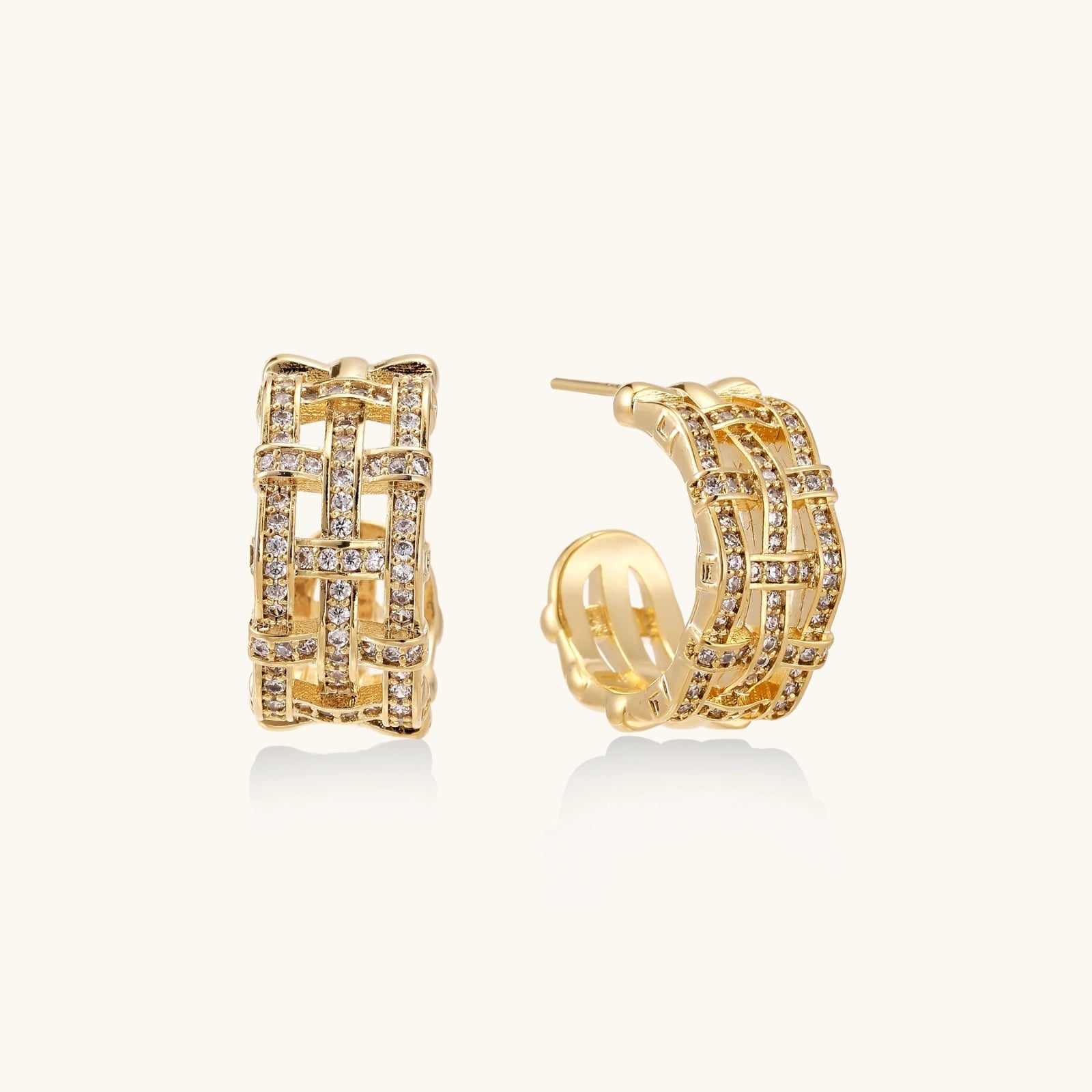 Gold hoop earrings with lattice design and embedded stones on a white background