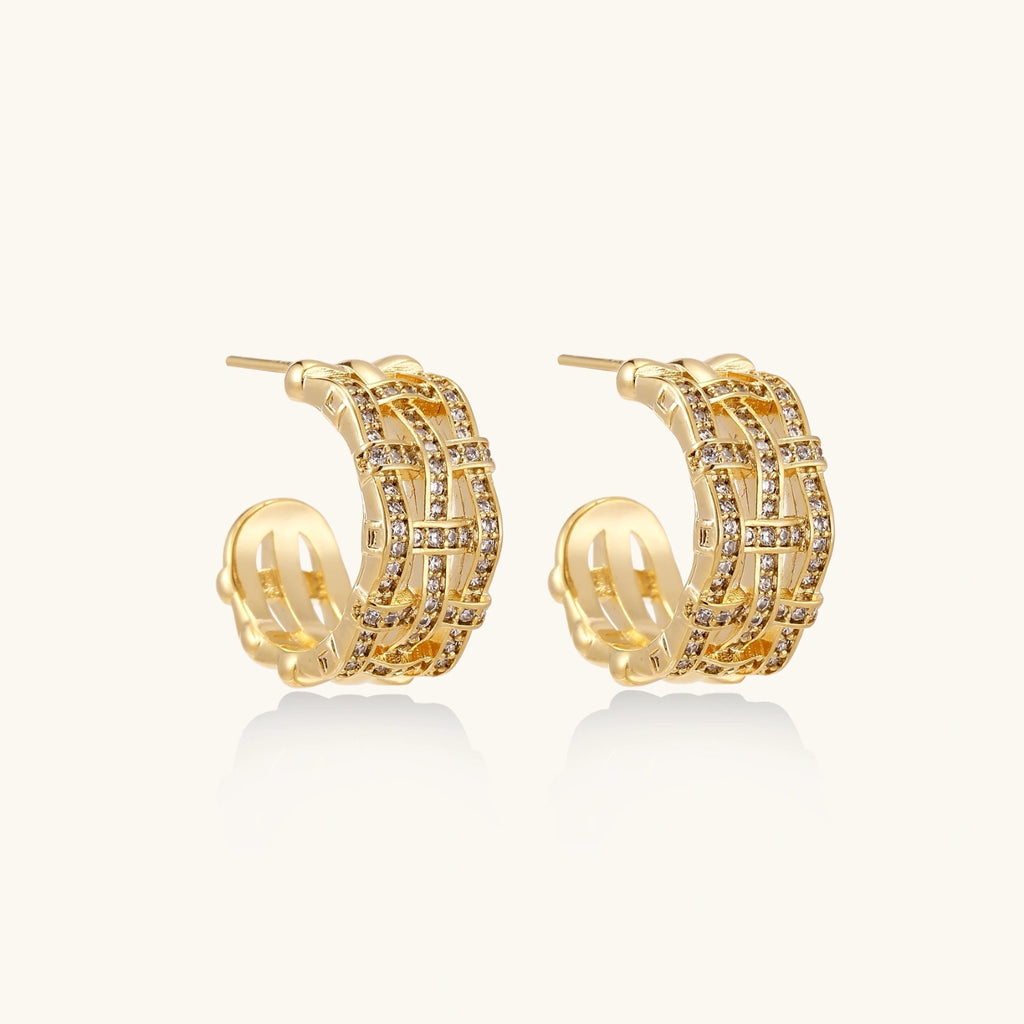 Gold hoop earrings with basket weave design and embedded stones on a white background