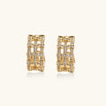 Gold hoop earrings with diamond accents on a white background