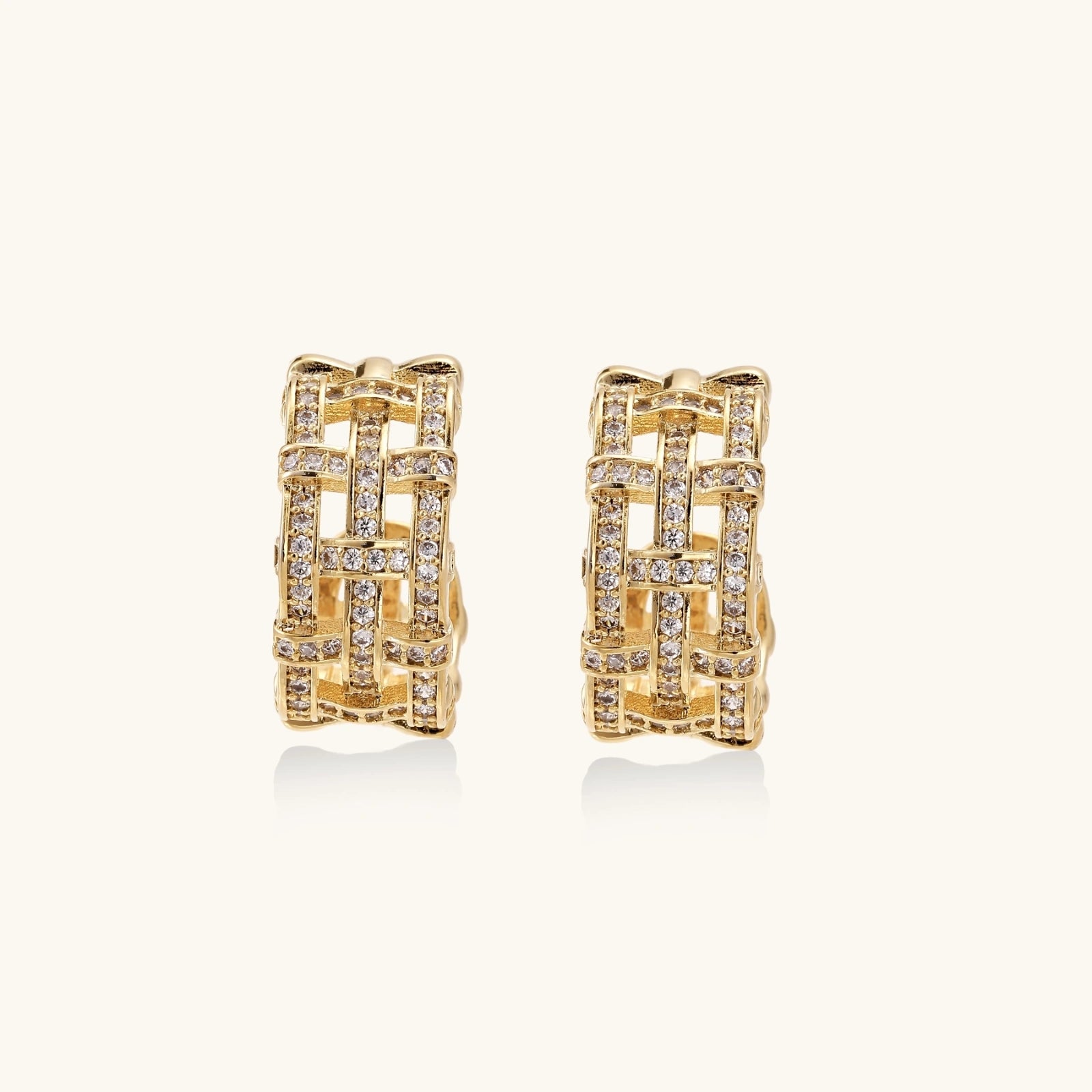 Gold hoop earrings with diamond accents on a white background
