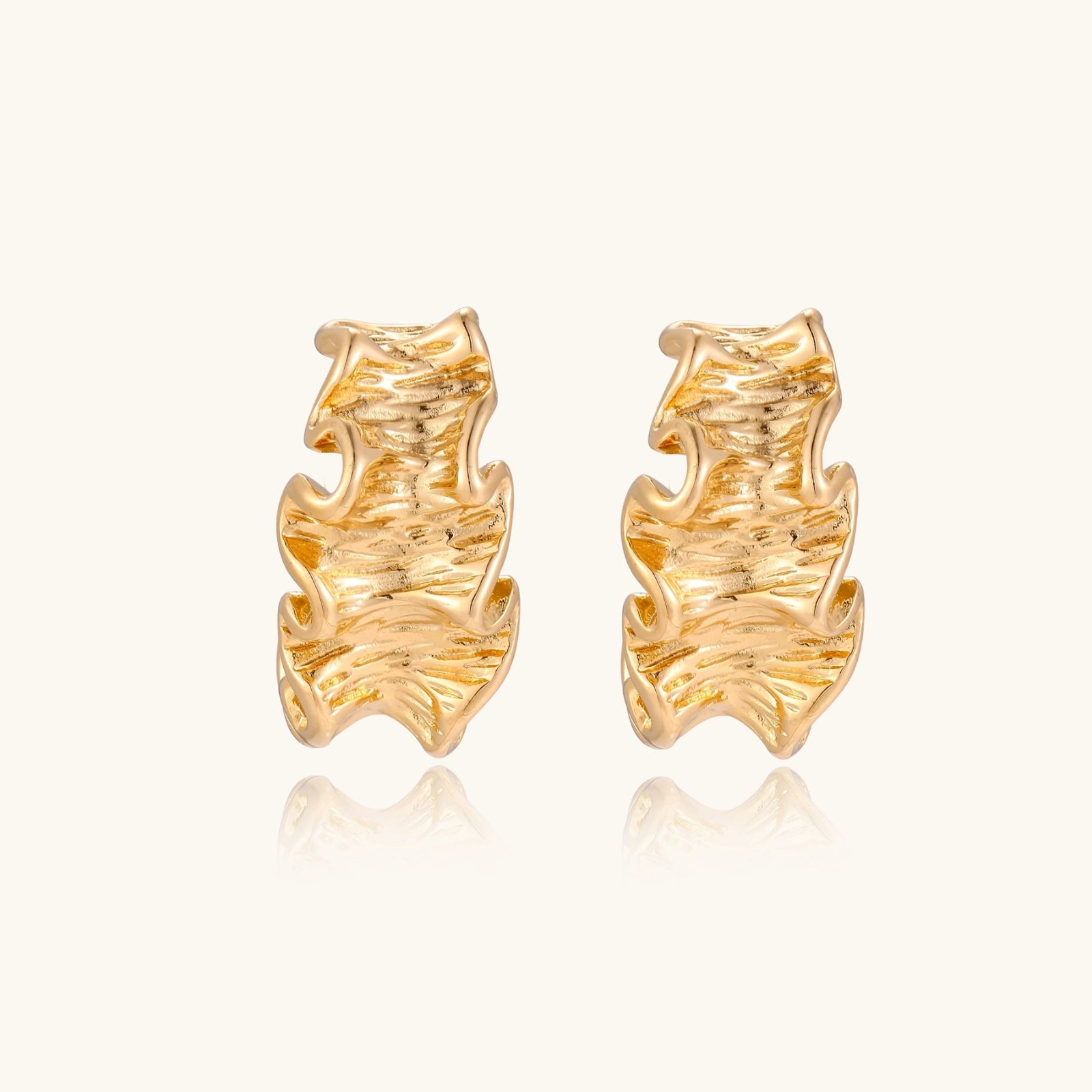 Pair of gold earrings on a white background