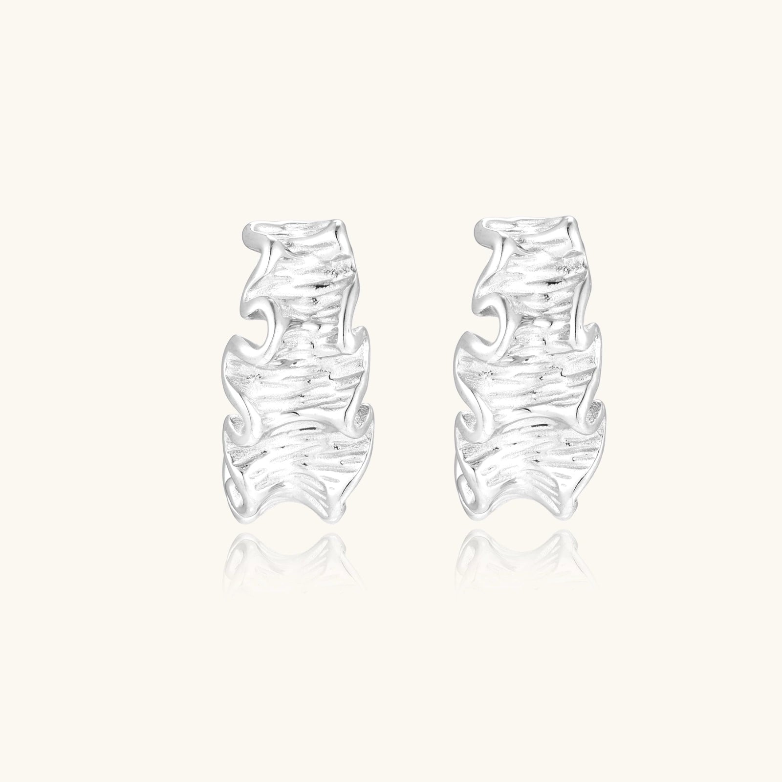 Pair of silver earrings on a white background