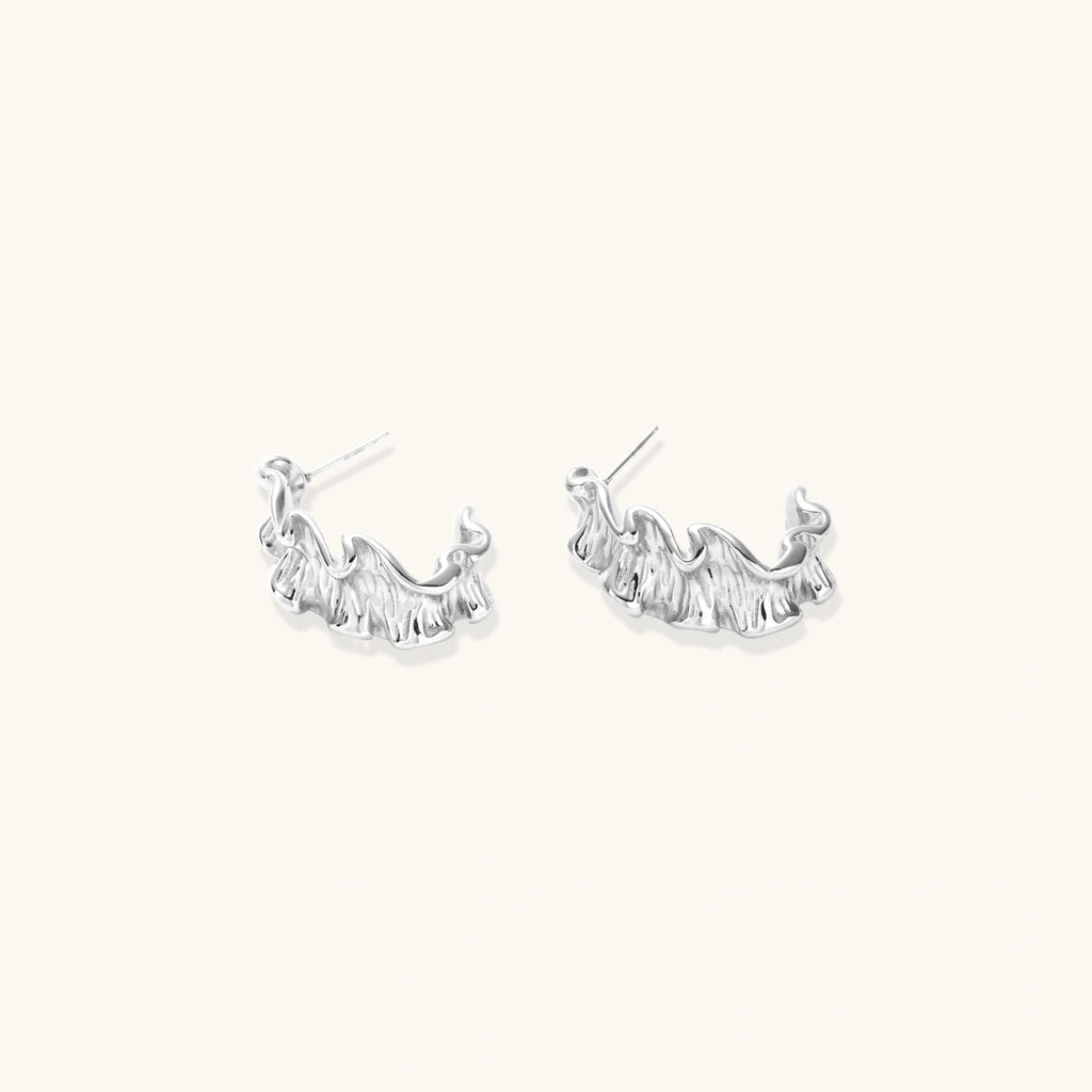 Pair of silver hoop earrings on a white background