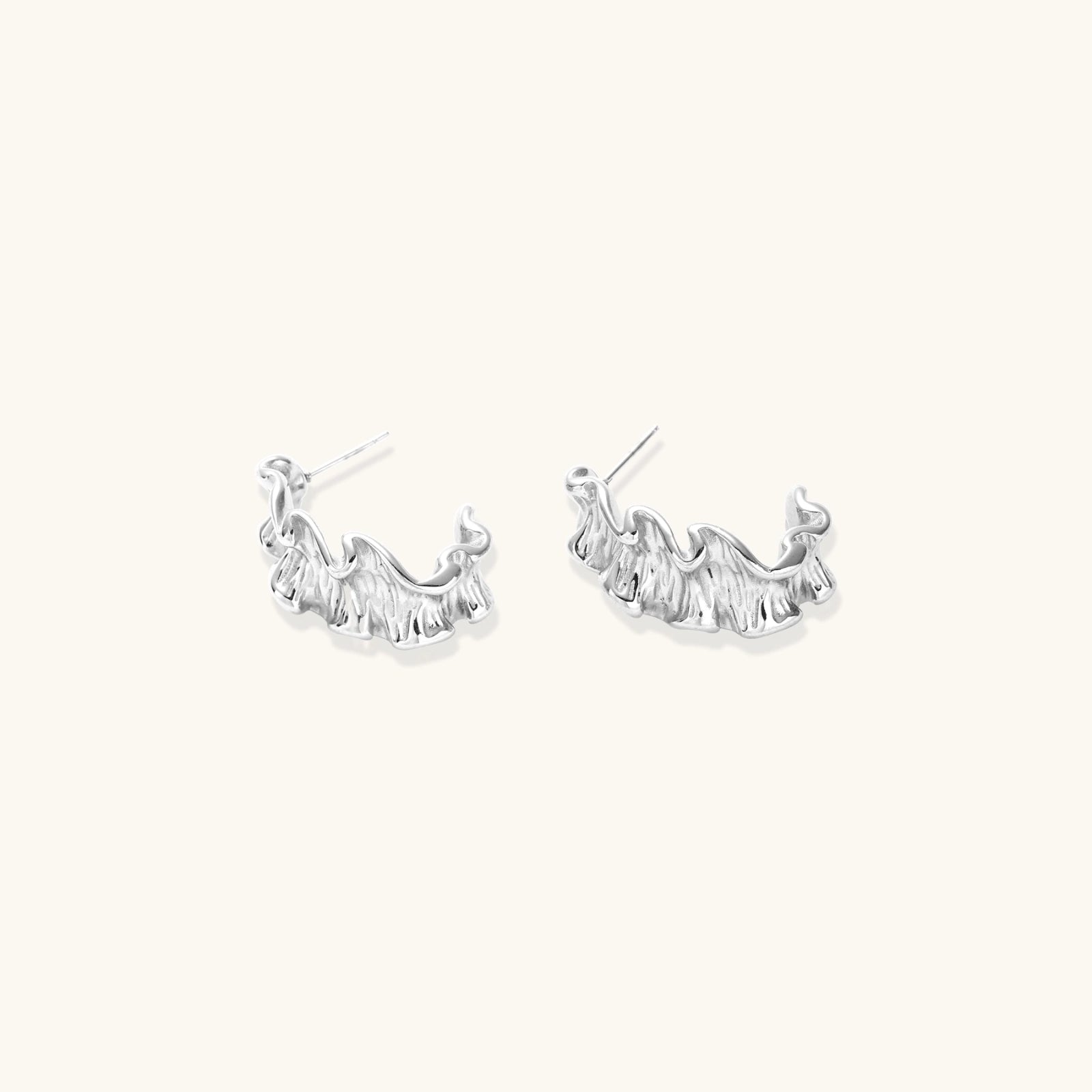 Pair of silver hoop earrings on a white background