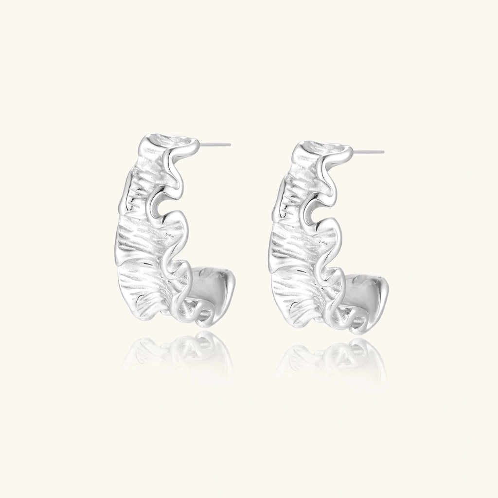 Silver hoop earrings on a white background