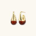 Gold and amber teardrop earrings on a white background
