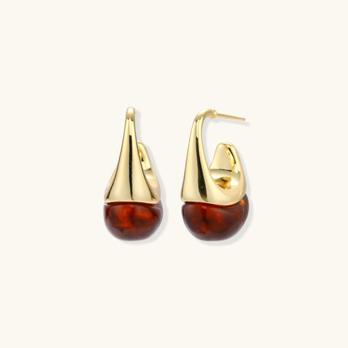 Gold and amber teardrop earrings on a white background