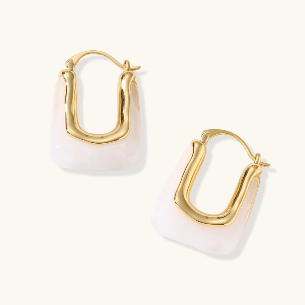 Gold hoop earrings on a white background
