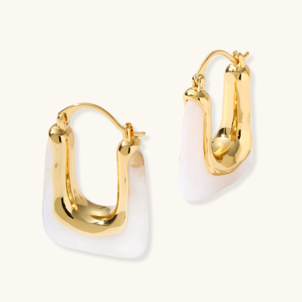 Gold hoop earrings on a white background