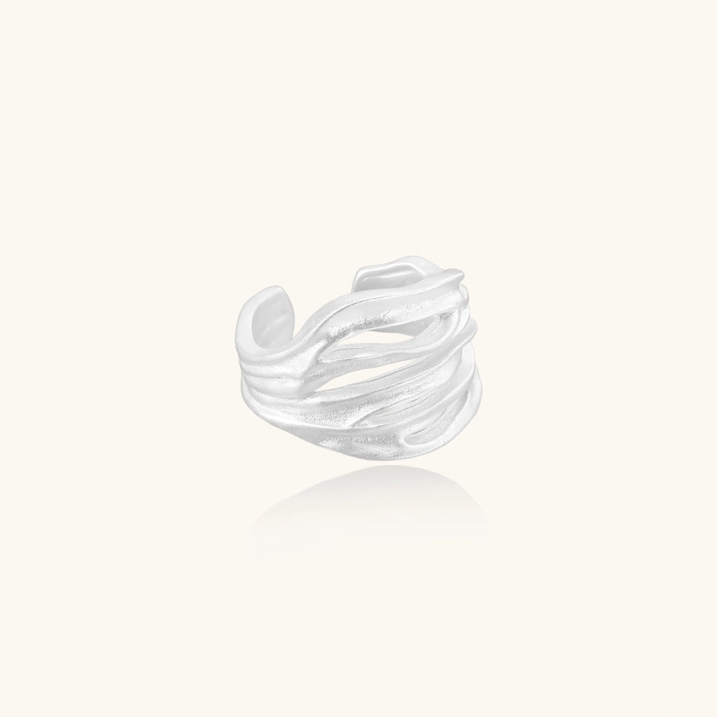 sterling silver ring with wavy design on a white background