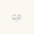 Silver ring with ridge design on a white background