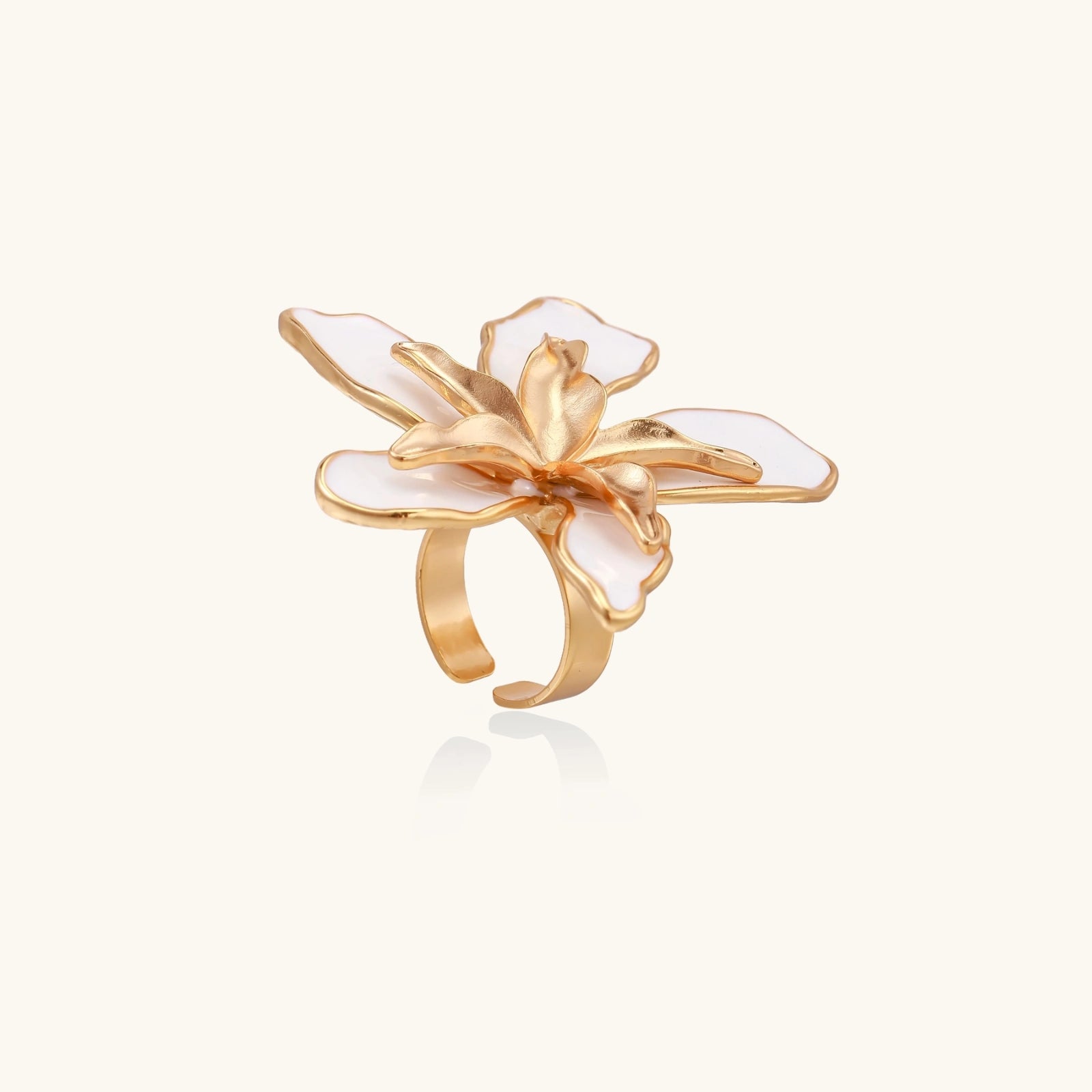 Gold ring with a white floral design on a white background