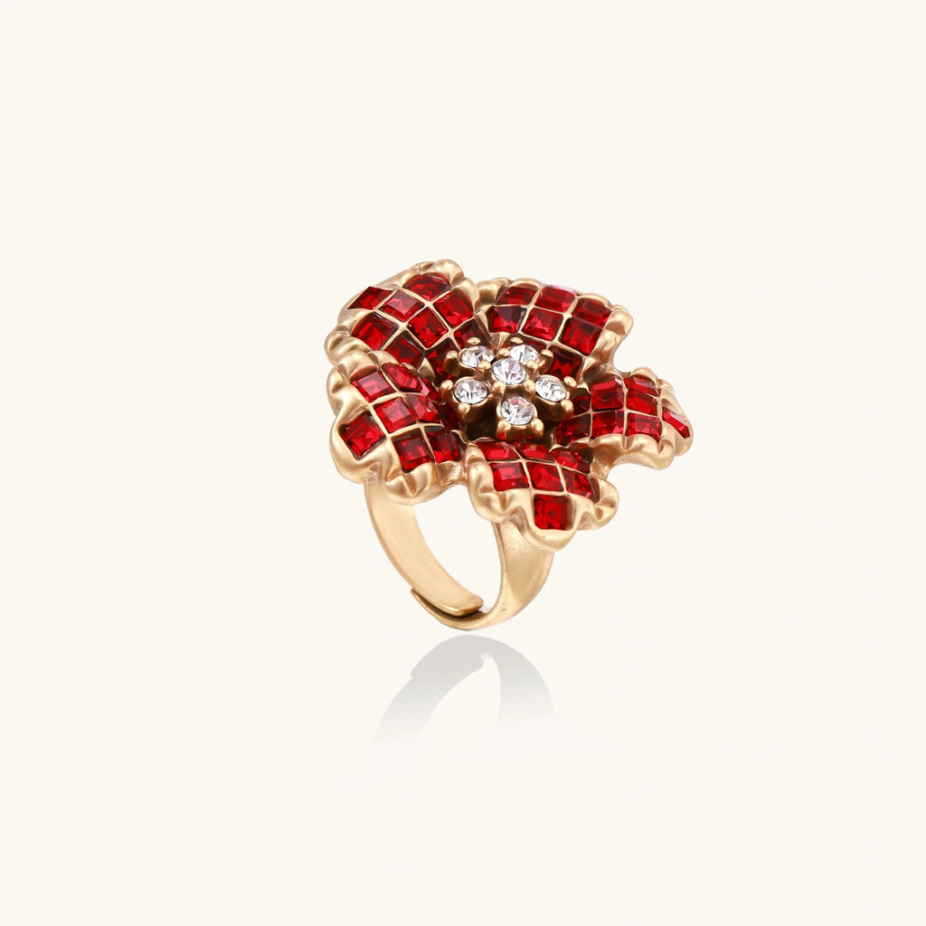 Gold ring with red gemstones on a white background
