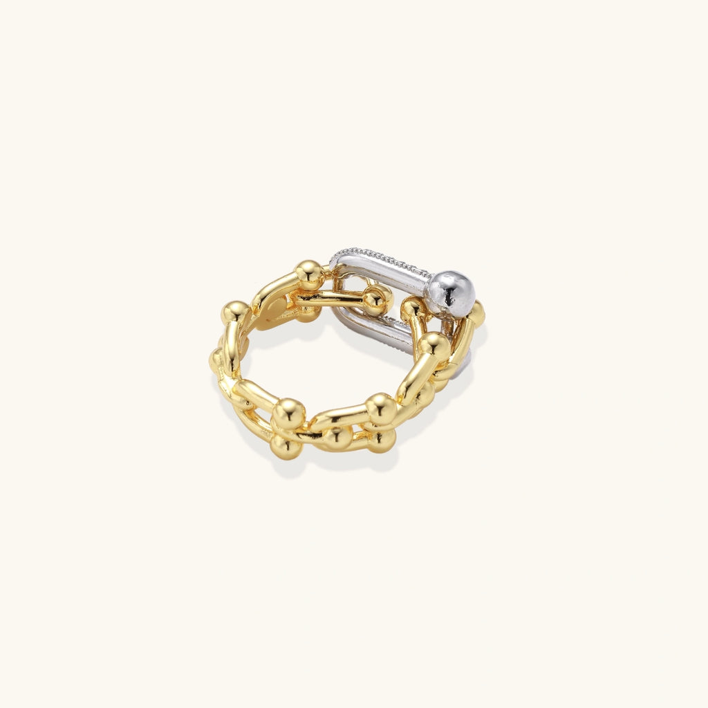 Gold and silver chain-style ring on a white background