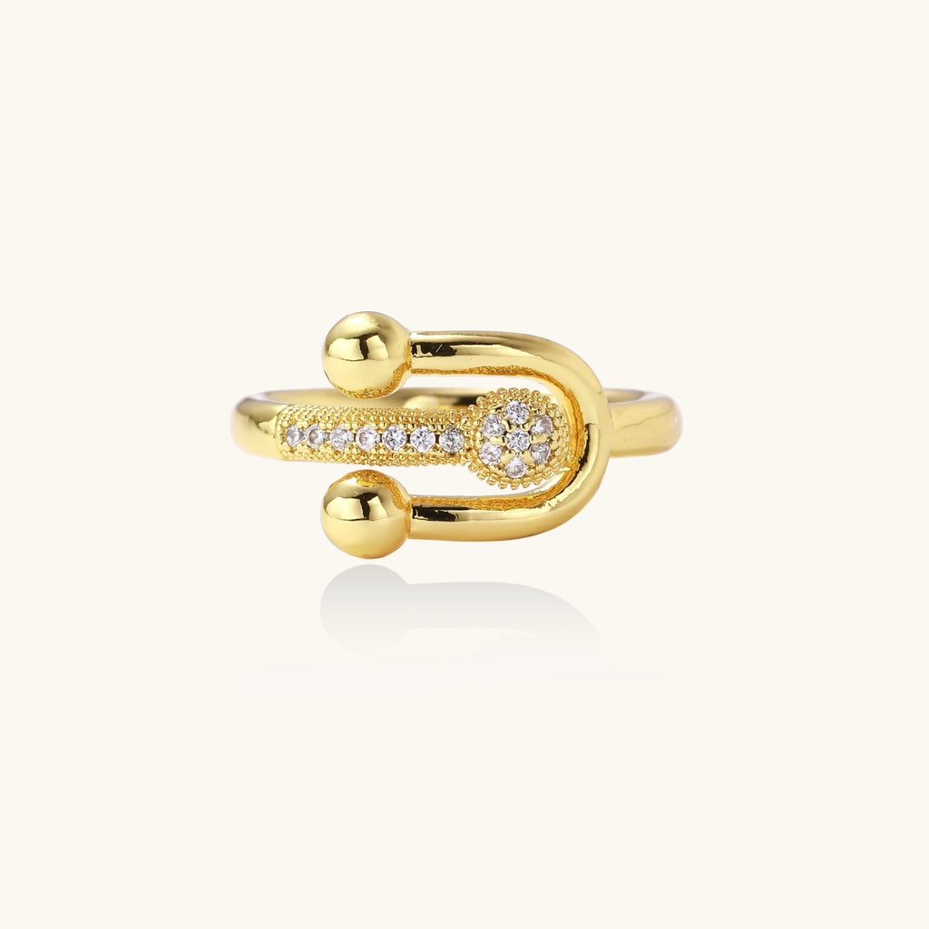 Gold ring with diamond accents on a white background