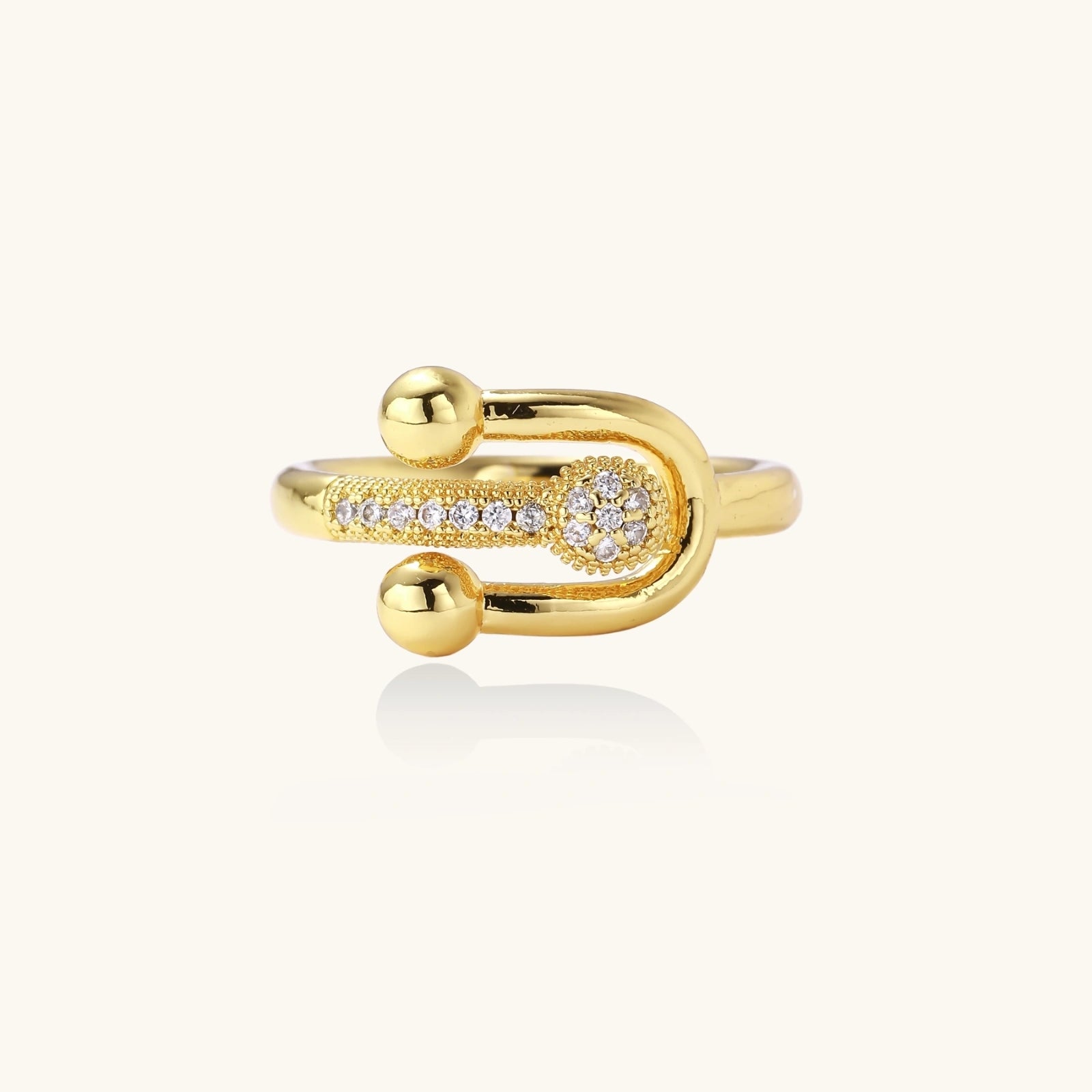 Gold ring with diamond accents on a white background