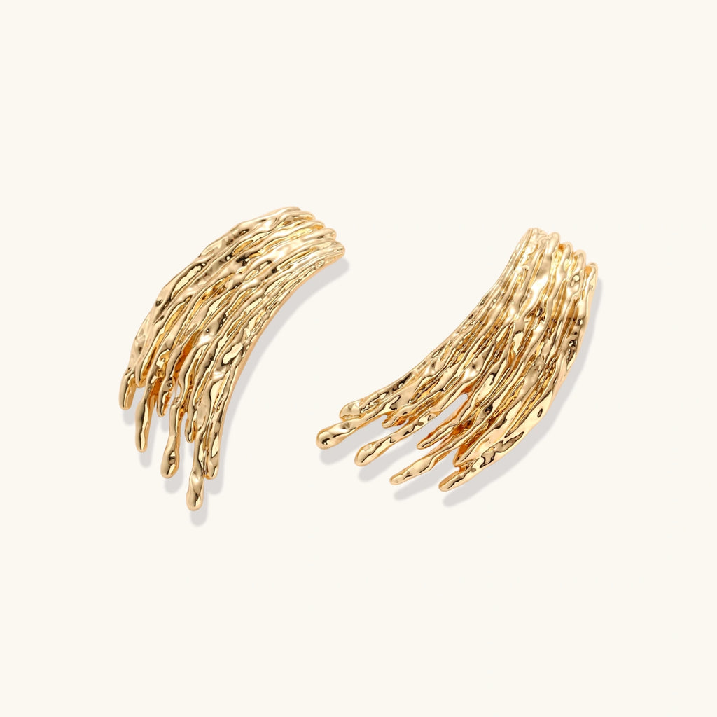 Gold branch-like earrings on a white background