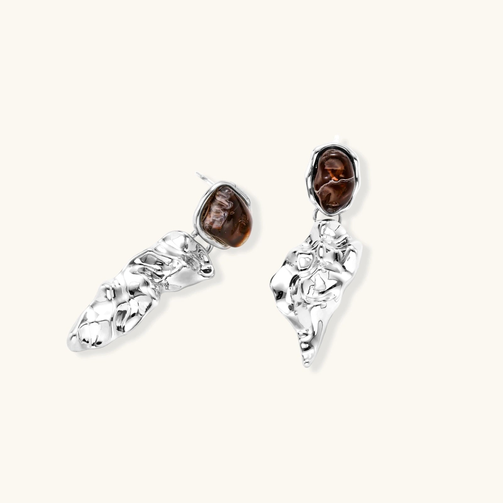 Pair of silver earrings with brown gemstones on a white background