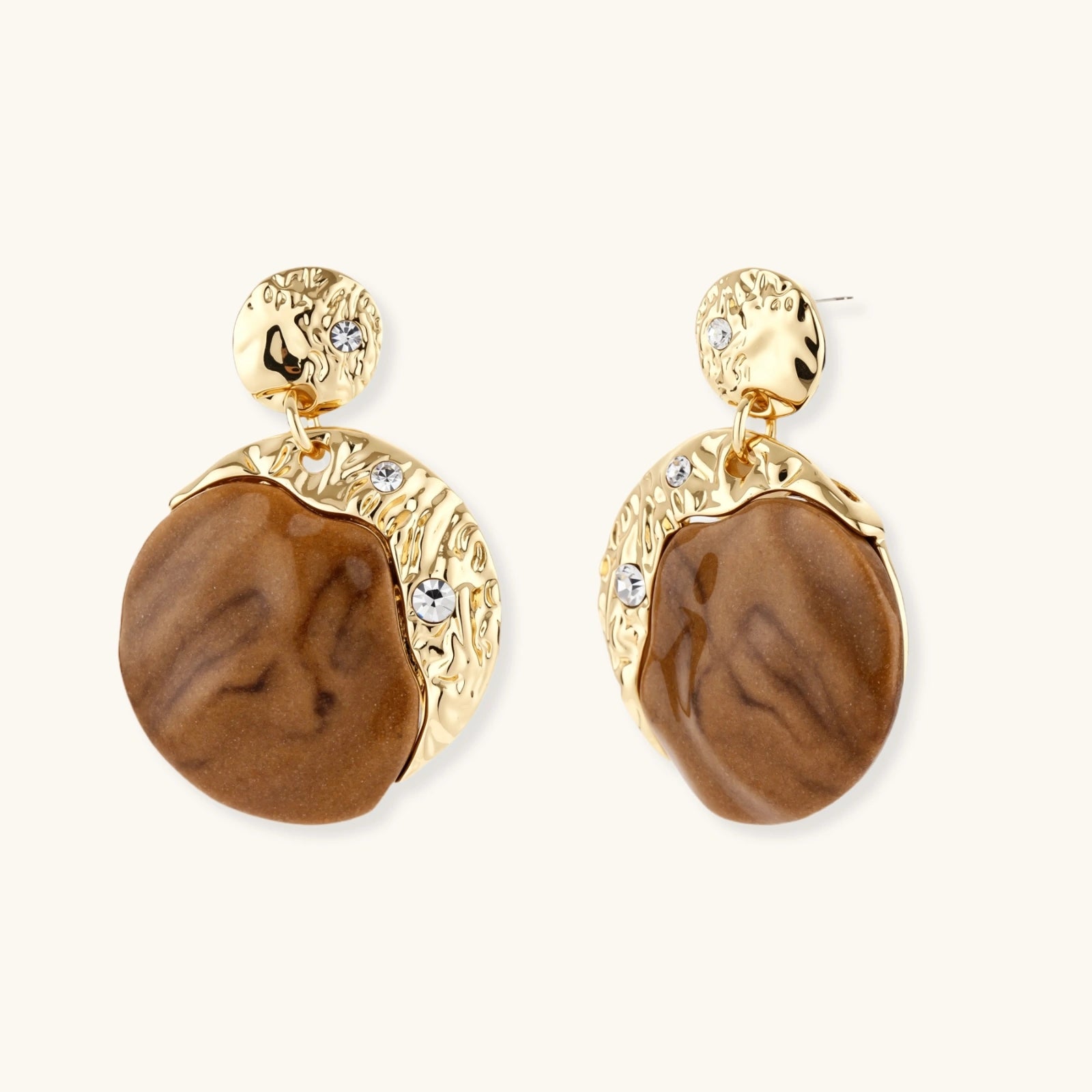 Gold and brown earrings with rhinestones on a white background