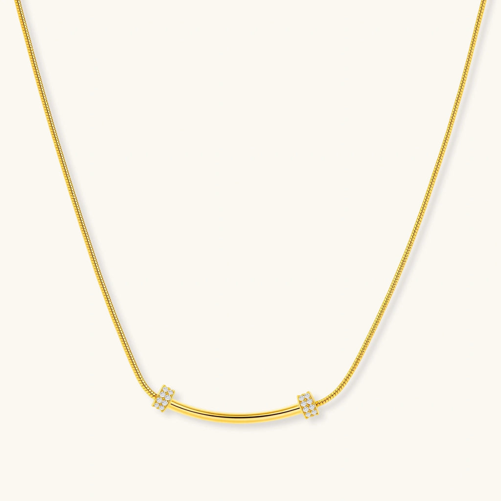 Gold necklace with small diamond-like pendants on a white background