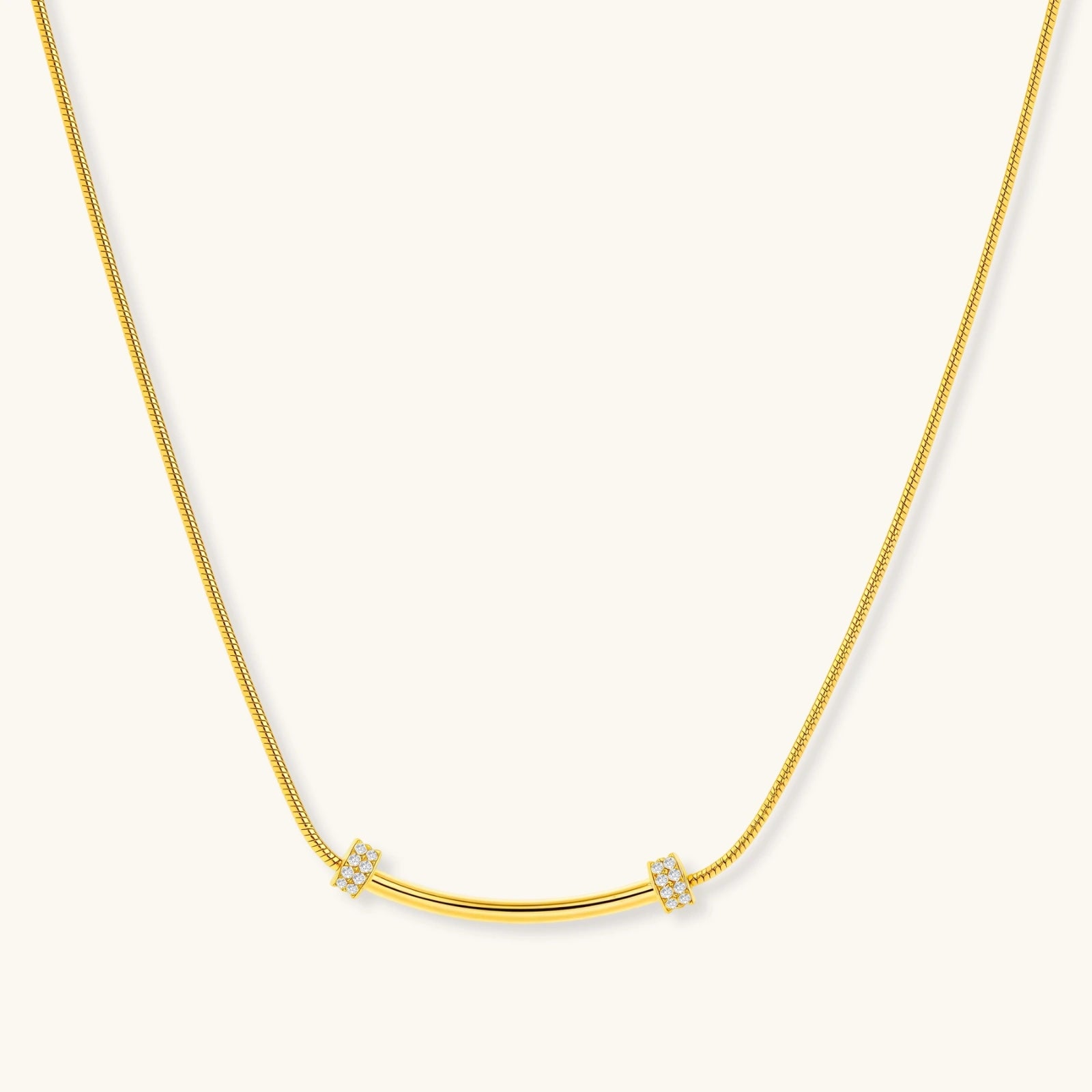 Gold necklace with small diamond-like pendants on a white background