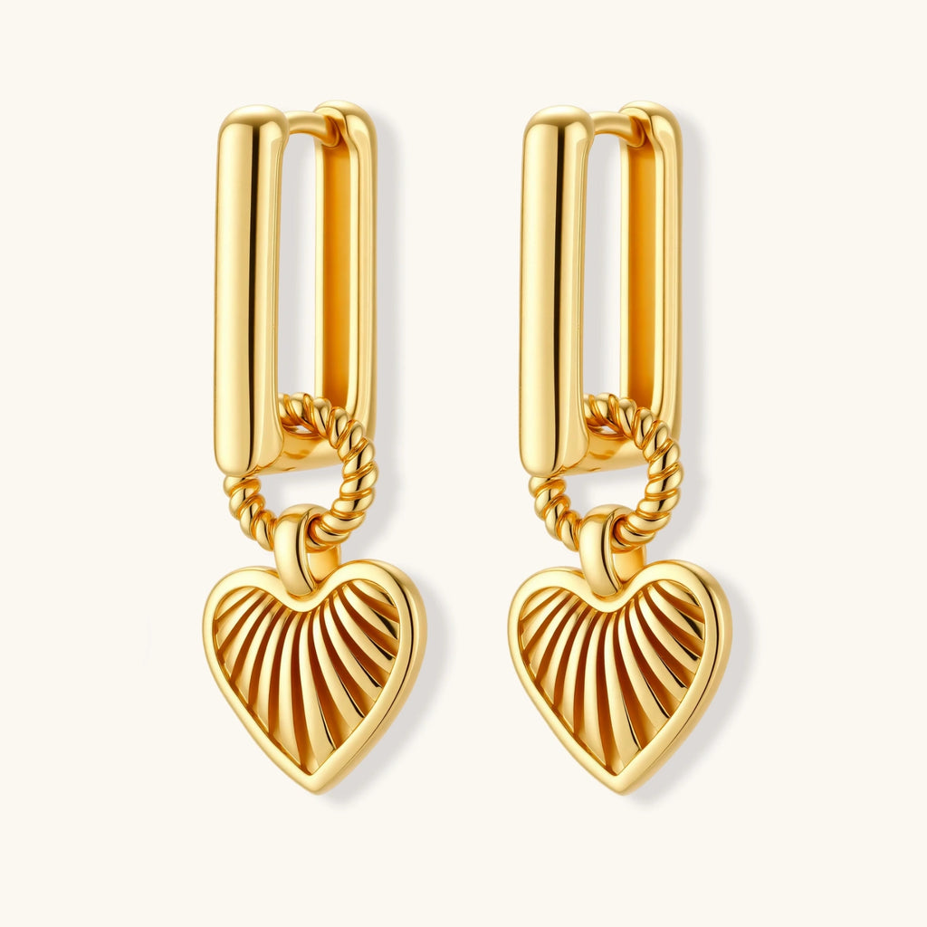 Gold heart-shaped earrings on a white background
