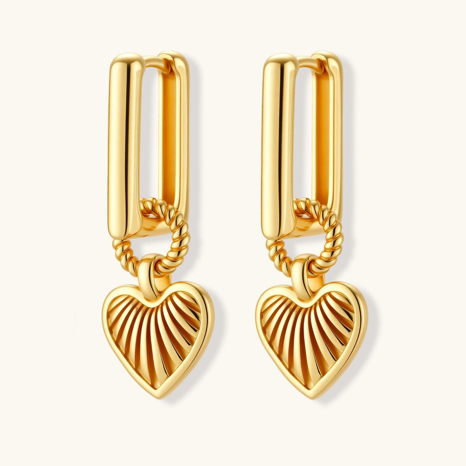 Gold heart-shaped earrings on a white background