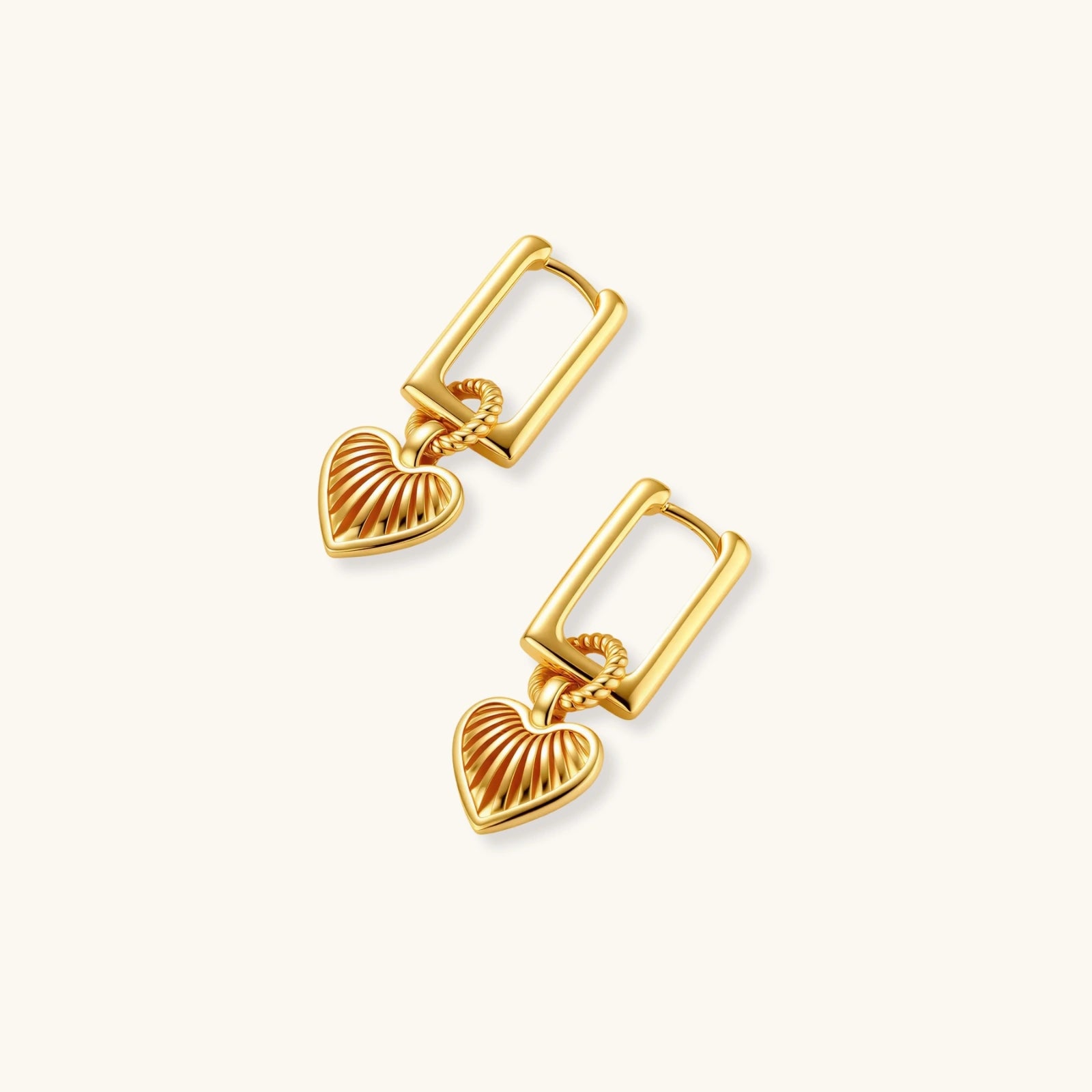 Gold heart-shaped earrings on a white background