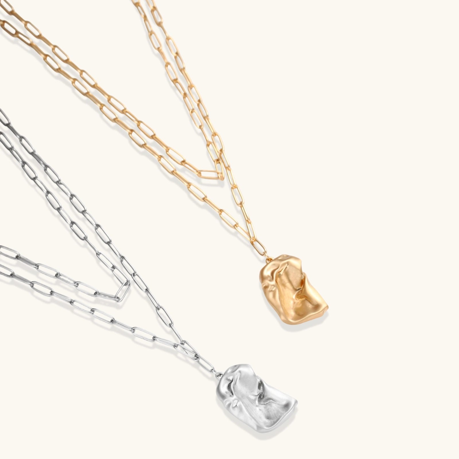 Two necklaces with unique pendants on a white background