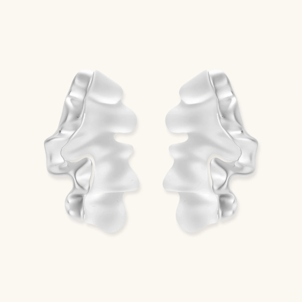 Pair of silver ruffled earrings on a white background