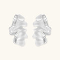 Pair of silver ruffled earrings on a white background