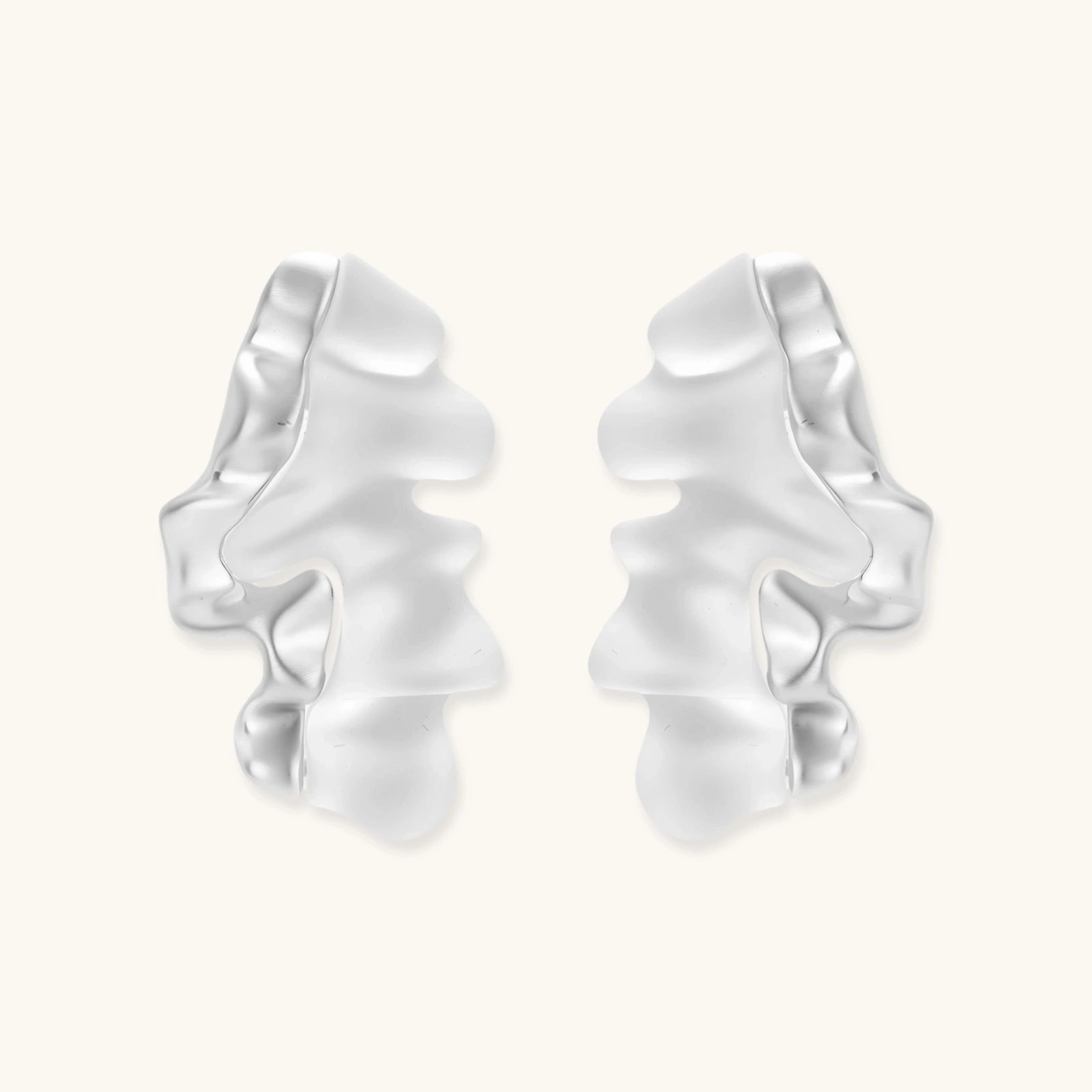 Pair of silver ruffled earrings on a white background