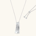 Silver necklace with a fringe pendant on a white background