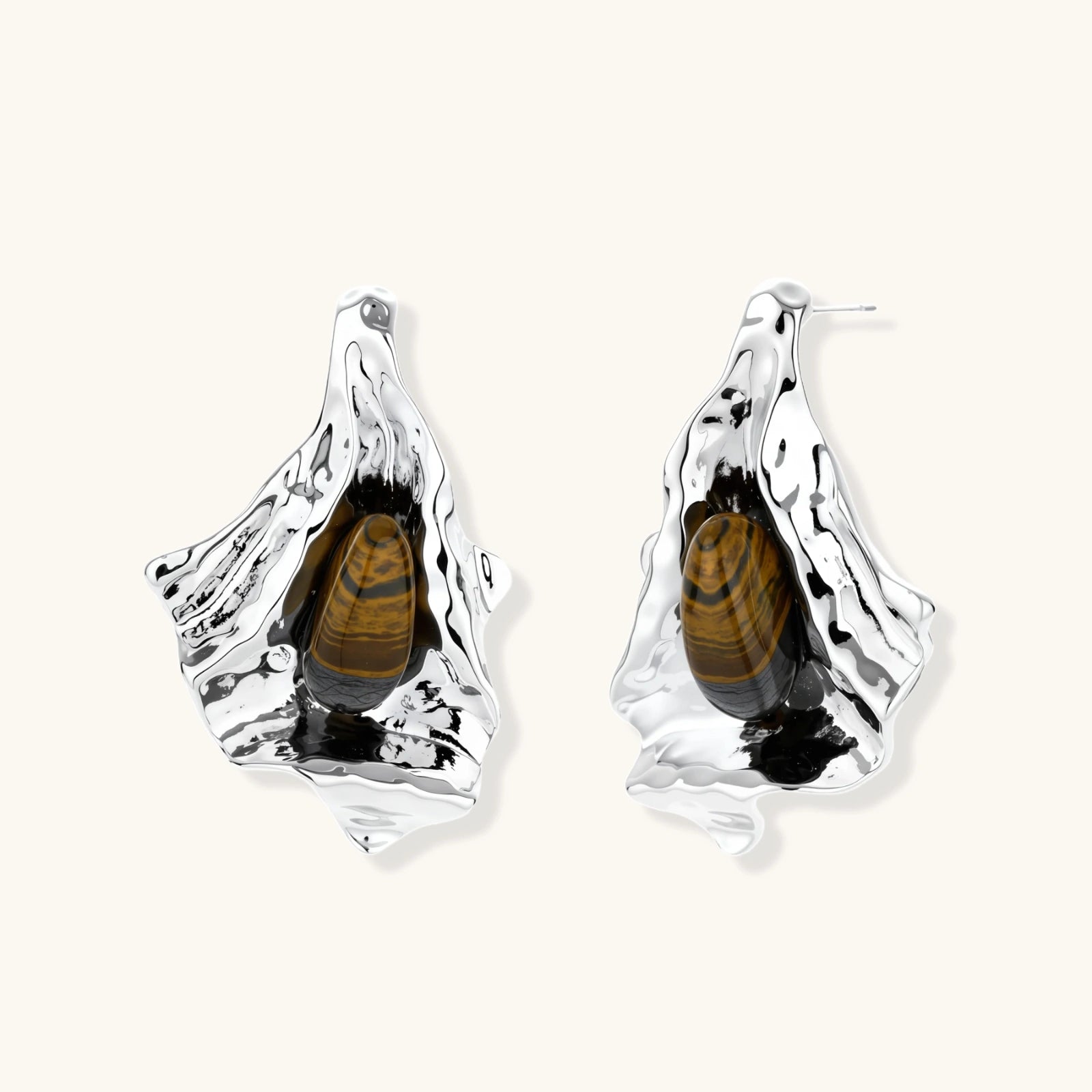 Silver earrings with embedded beetles on a white background