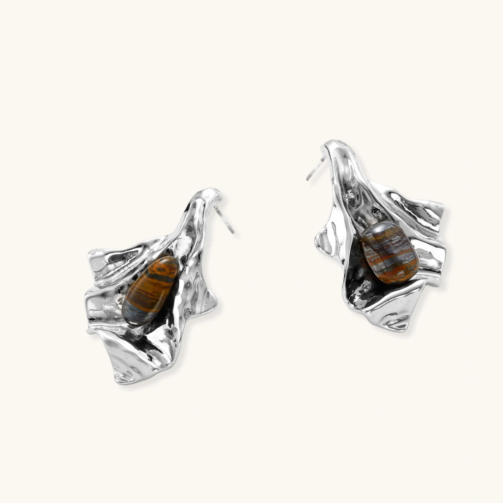 Silver earrings with embedded stones on a white background