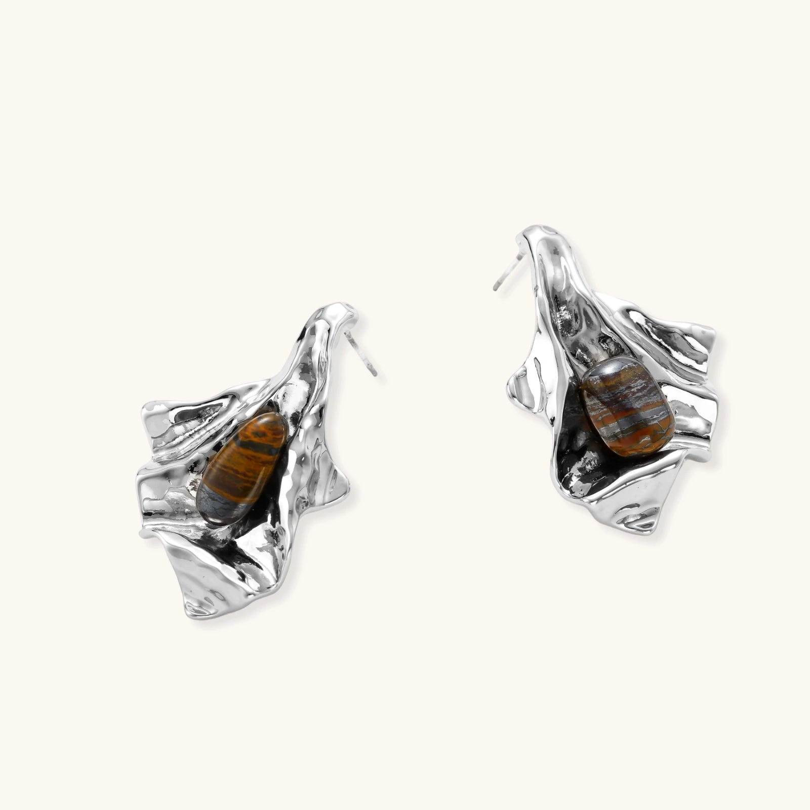 Silver earrings with embedded stones on a white background