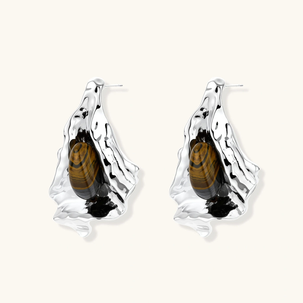 Silver earrings with embedded tiger eye stones on a white background