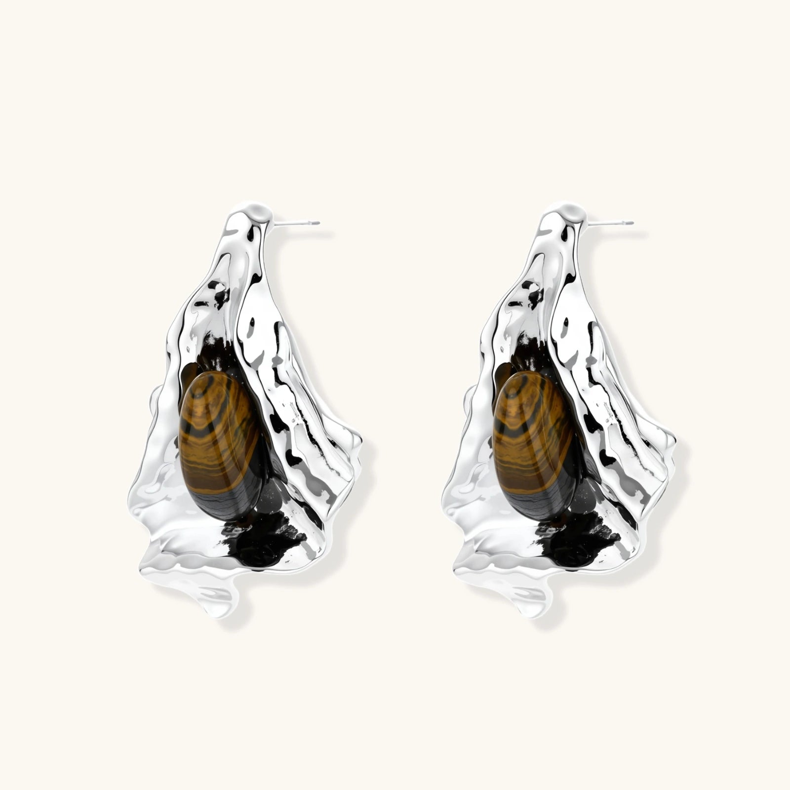 Silver earrings with embedded tiger eye stones on a white background