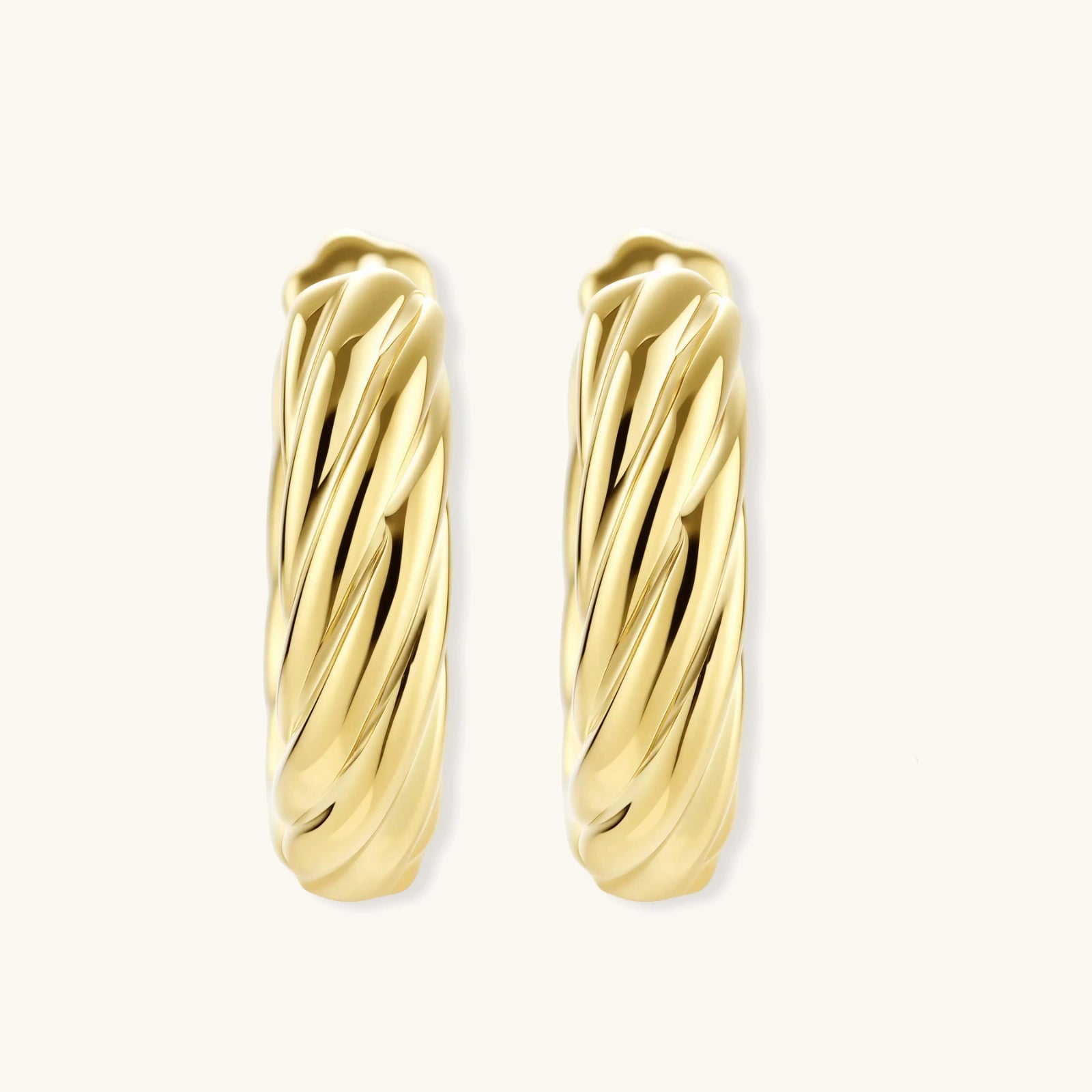Pair of gold hoop earrings on a white background