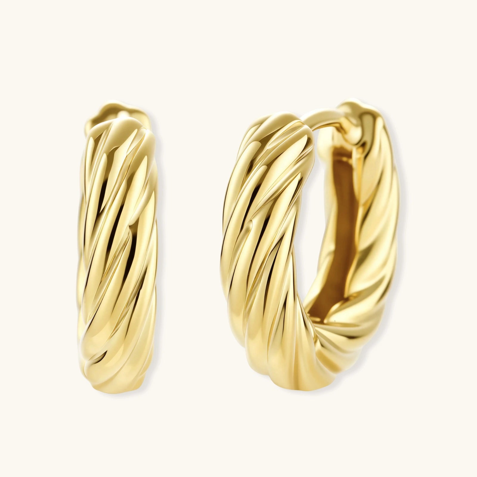 Gold hoop earrings on a white background