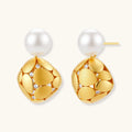 Gold earrings with pearl drops on a white background