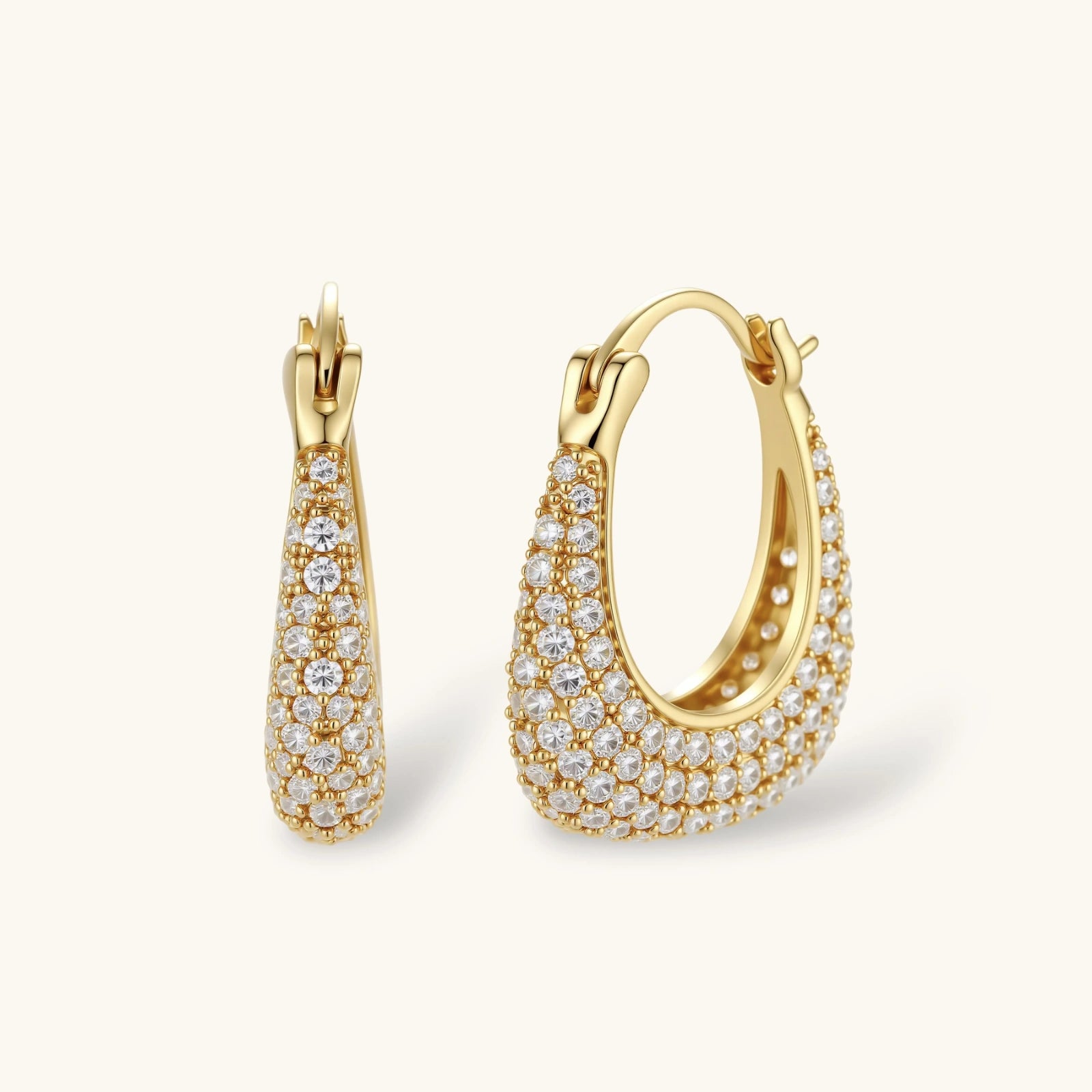 Gold hoop earrings with diamond accents on a white background