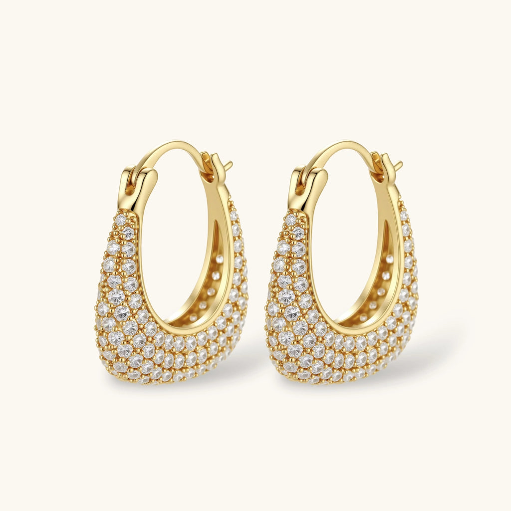 Gold hoop earrings with embedded stones on a white background
