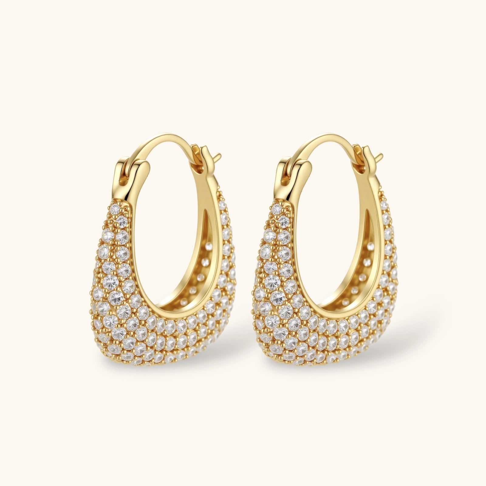 Gold hoop earrings with embedded stones on a white background