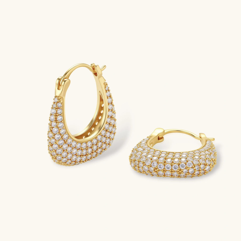 Gold hoop earrings with clear gemstones on a white background