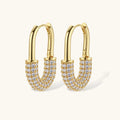 Gold hoop earrings with clear gemstones on a white background