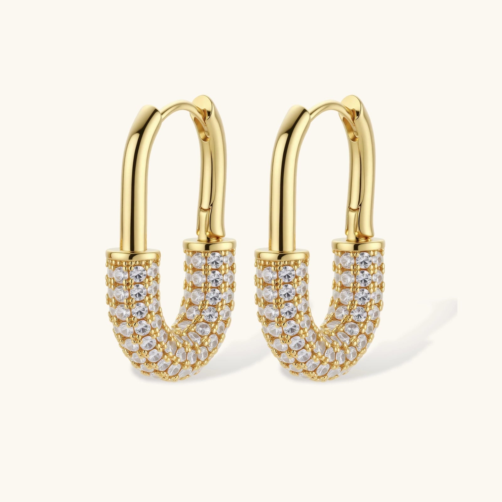 Gold hoop earrings with clear gemstones on a white background
