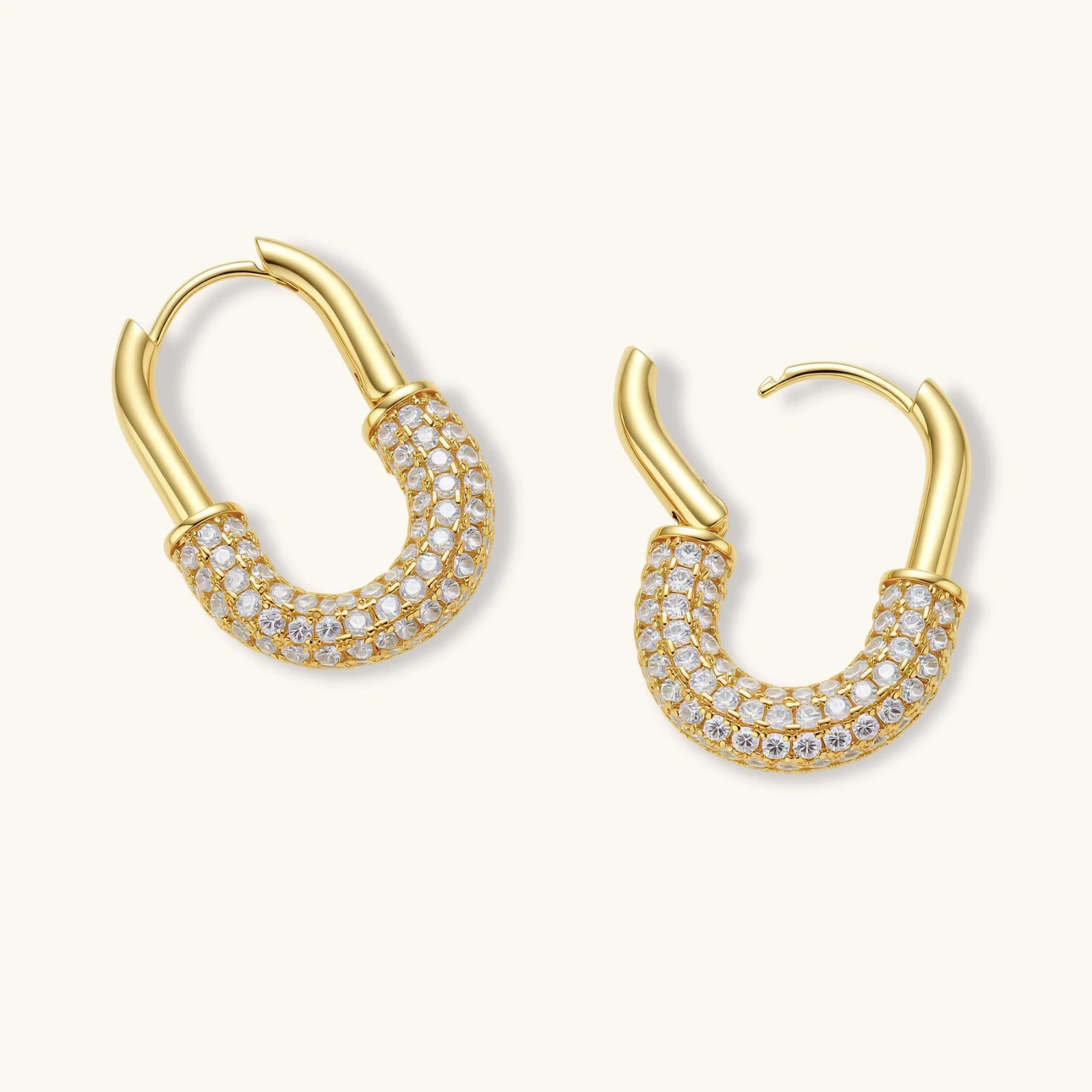 Gold hoop earrings with clear gemstones on a white background