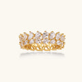 Gold ring with clear gemstones on a white background